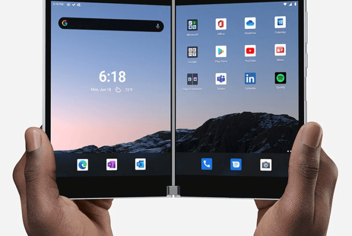 hands holding up the Surface Duo in open book mode